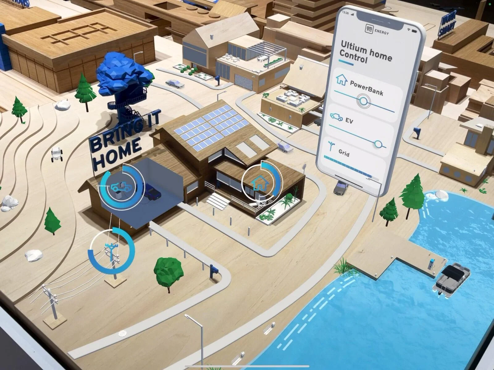 Sterowanie energią w AR i unoszący się interfejs telefonu nad makietą miasta GM Energy.